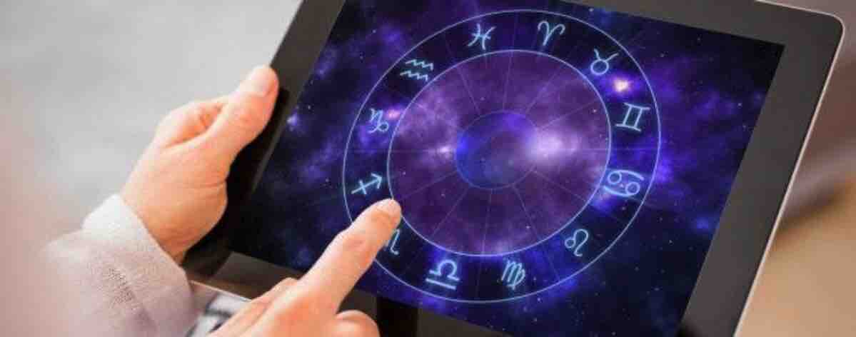 woman holding tablet with horoscope