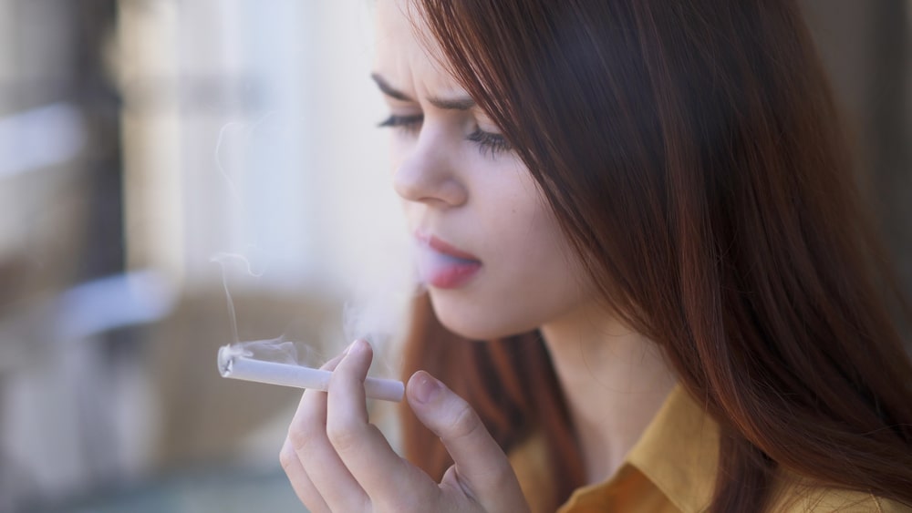 Woman smokes a cigarette