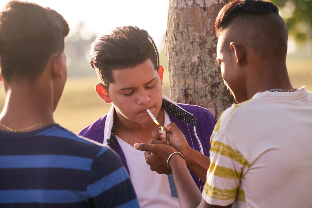 teenager smoking with peers