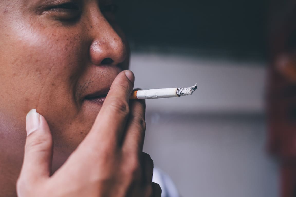 young man smoking cigarette