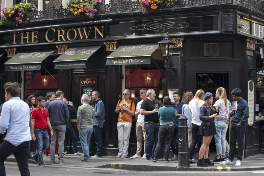 Men-and-women-drink-beer-and-smoke-outside-the-Crown-pub-near-Leicester-square- London